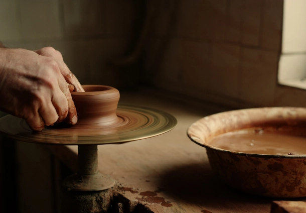 Photo of two hands doing pottery