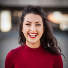 Photo of a woman in red laughing