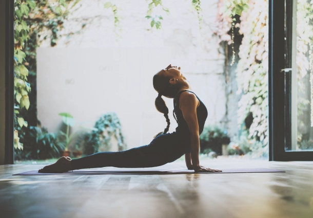 Woman stretching doing a yoga stance on a matt